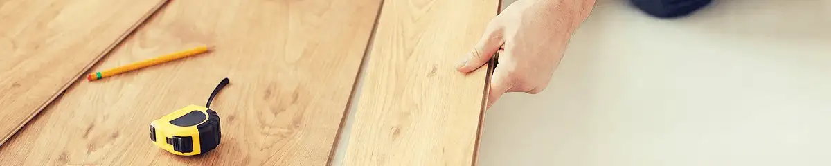 A professional installing wood flooring in Stamford, CT