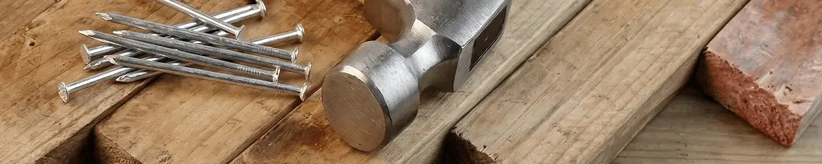 Hammer and nails on hardwood flooring boards in Stamford, CT
