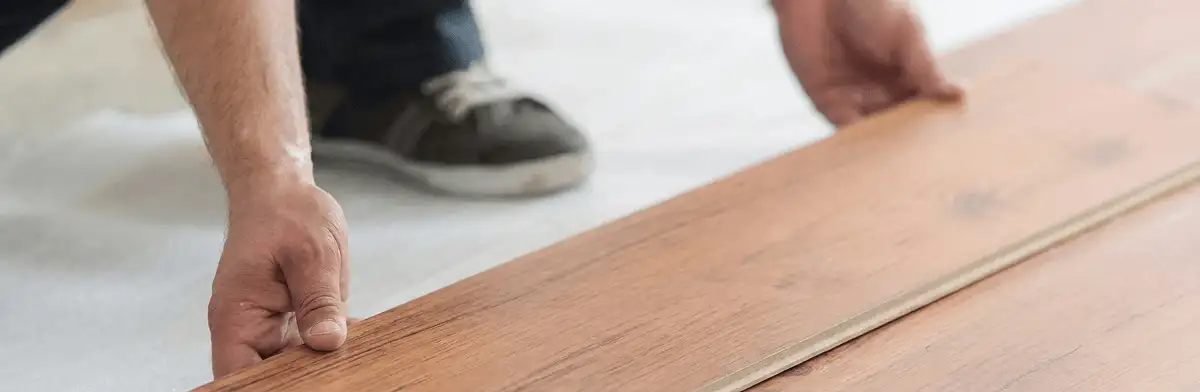 A professional installing laminate flooring in Stamford, CT
