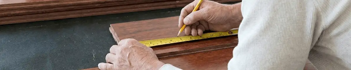 A professional installing wood flooring in Stamford, CT